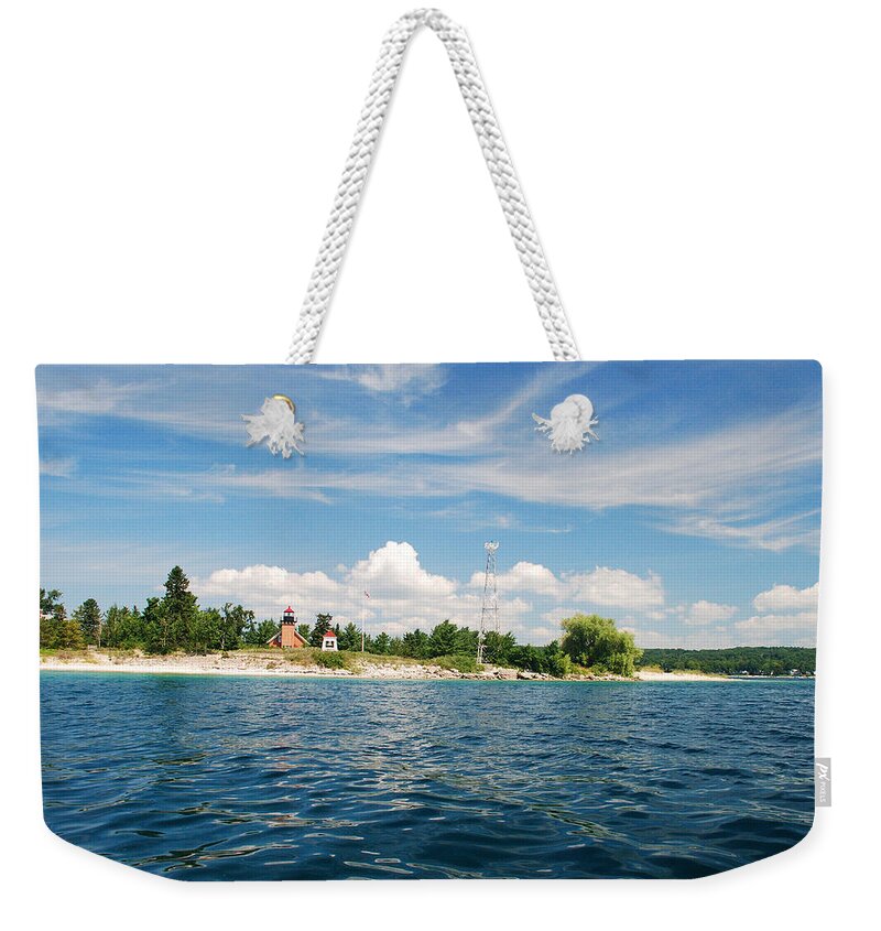 Little Traverse Lighthouse Weekender Tote Bag featuring the photograph Across The Bay To The Light by Janice Adomeit