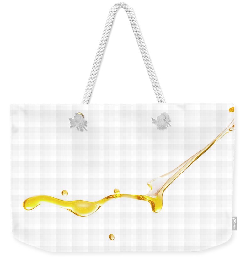 Motor Oil Weekender Tote Bag featuring the photograph Active Oil Splash In White Background by Yaorusheng