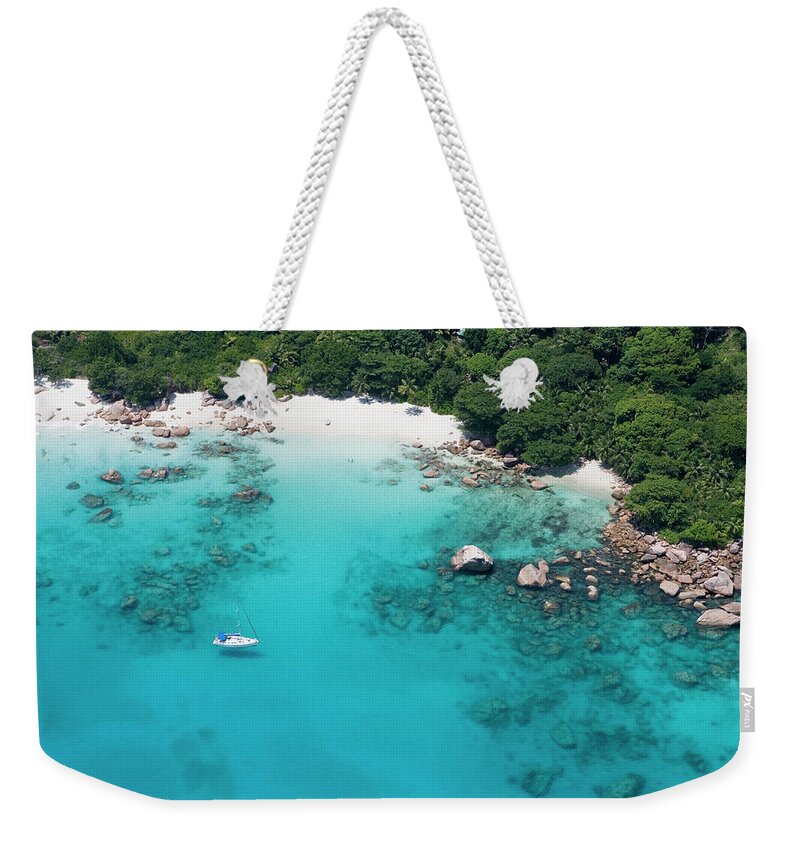 Sailboat Weekender Tote Bag featuring the photograph Aerial Of Sailboat Off Anse Lazio by Holger Leue