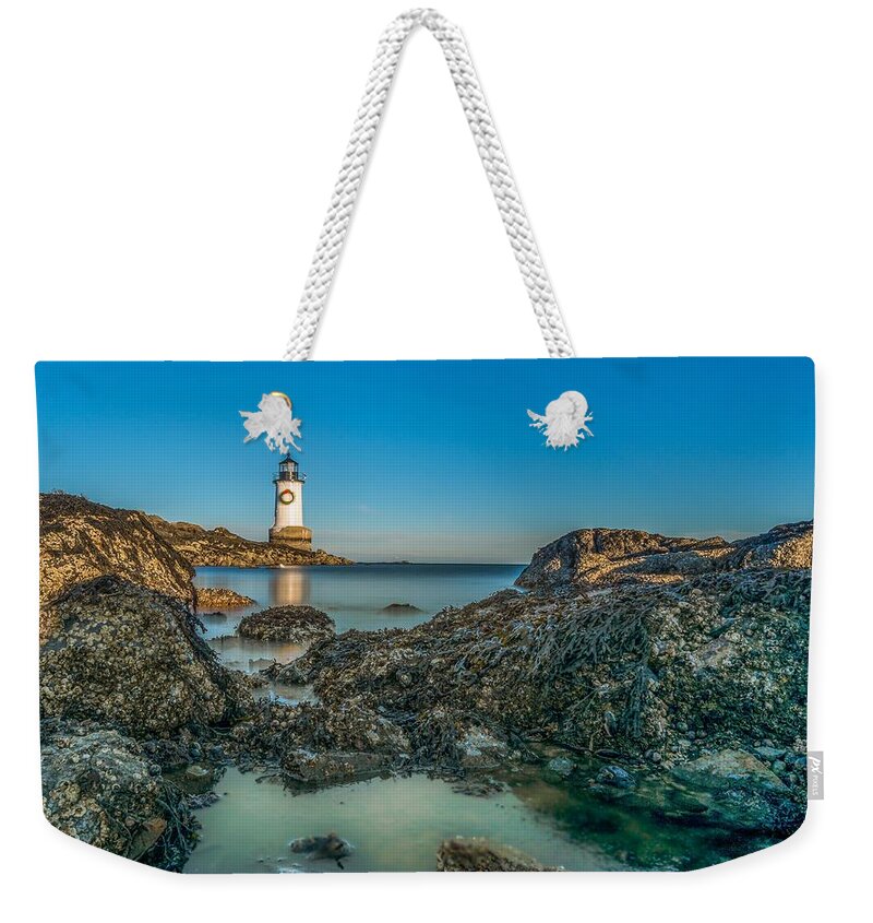Lighthouse Weekender Tote Bag featuring the photograph An early moon over Fort Pickering Light Salem MA by Bryan Xavier
