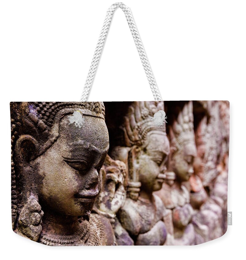 Statue Weekender Tote Bag featuring the photograph Angkor Wat Temple Wall Faces Detail by Daniel Osterkamp