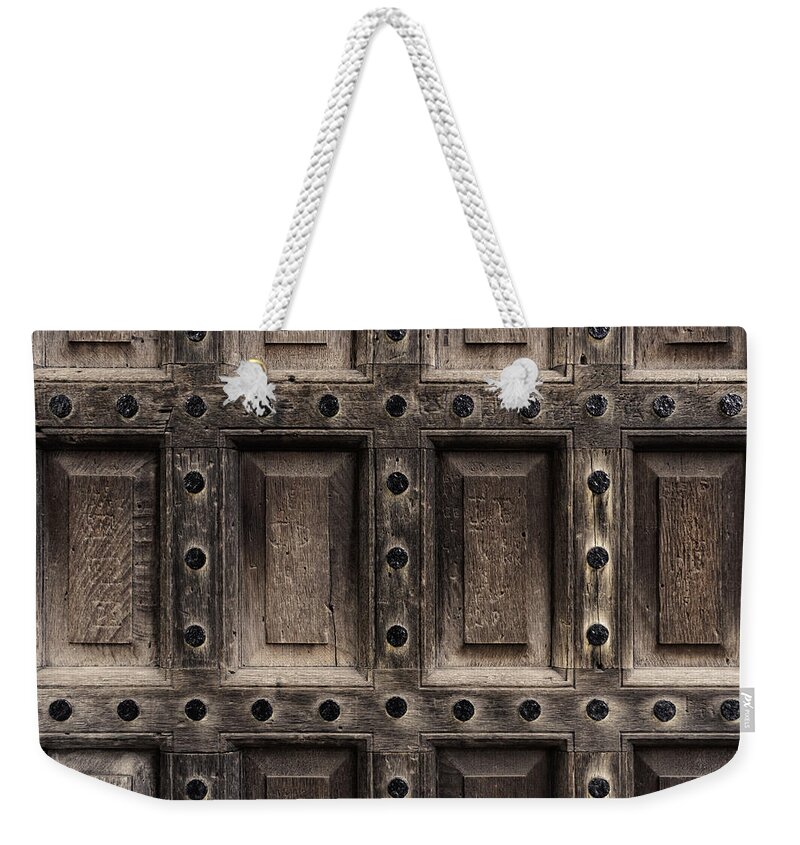 Wood Weekender Tote Bag featuring the photograph Antique wooden door closeup by Dutourdumonde Photography