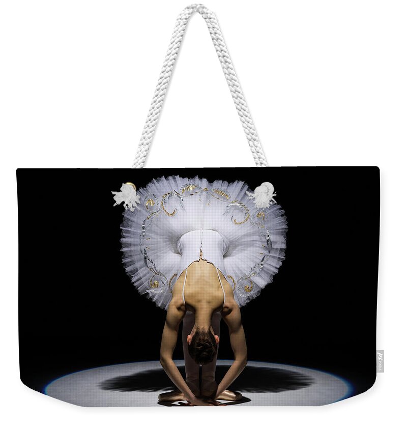 Ballet Dancer Weekender Tote Bag featuring the photograph Ballerina In Tutu Folding Forward Under by Nisian Hughes
