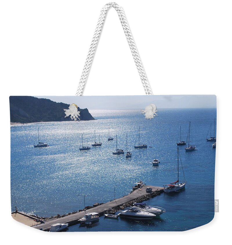 Blue Water At Noon Weekender Tote Bag featuring the photograph Bay of Porto by George Katechis