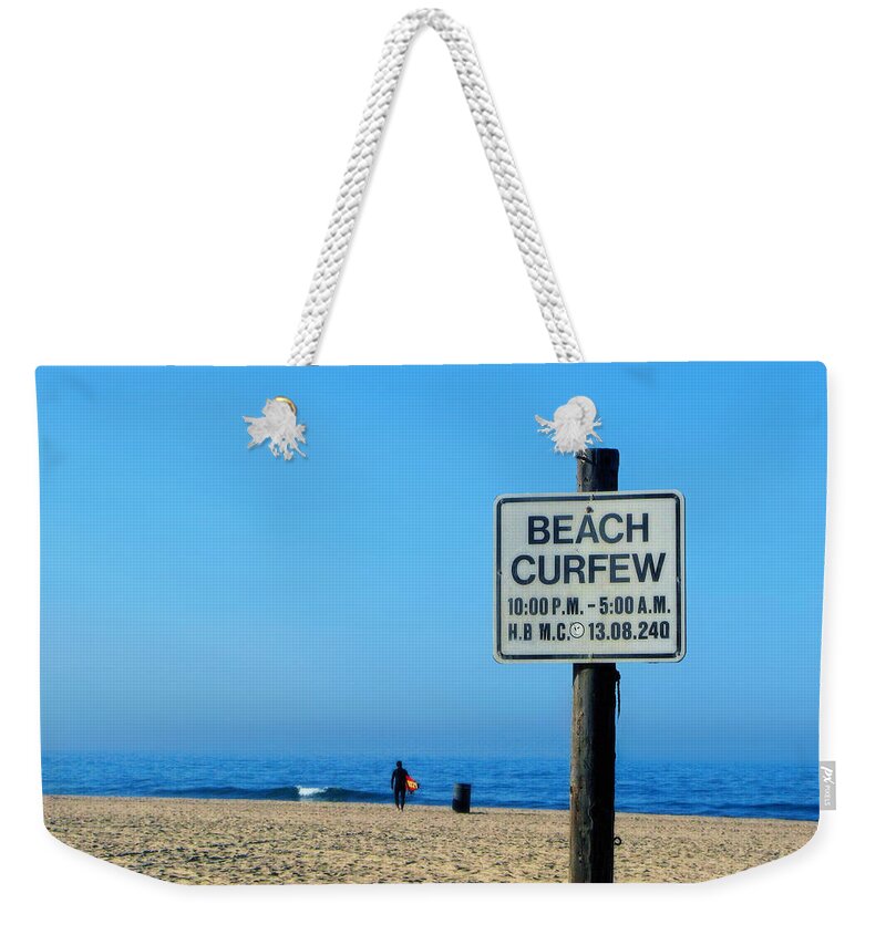 Ocean Weekender Tote Bag featuring the photograph Beach curfew by Tammy Espino