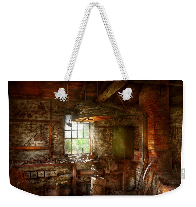 Self Weekender Tote Bag featuring the photograph Blacksmith - Breathing life into metal by Mike Savad