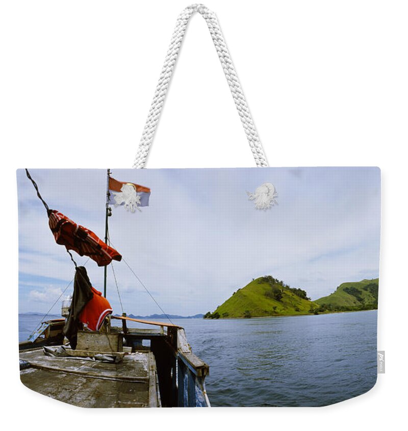 Photography Weekender Tote Bag featuring the photograph Boat In The Sea With Islands by Panoramic Images