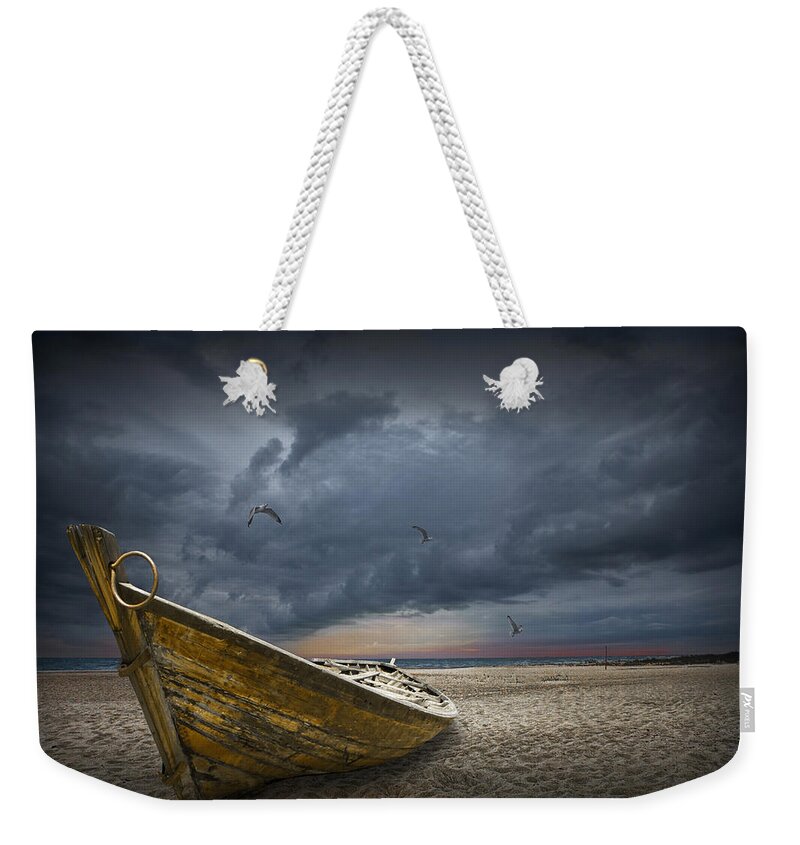 Art Weekender Tote Bag featuring the photograph Boat with gulls on the beach with oncoming storm by Randall Nyhof