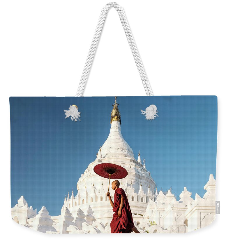 Pagoda Weekender Tote Bag featuring the photograph Buddhist Monk Walking Across Arches Of by Martin Puddy