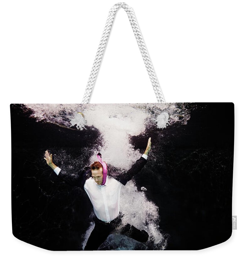 People Weekender Tote Bag featuring the photograph Businessman In Suit Plunging Into Water by Thomas Barwick