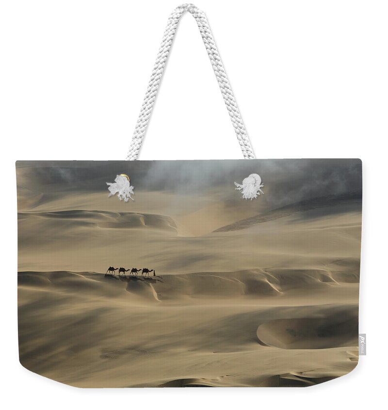 Scenics Weekender Tote Bag featuring the photograph Camel Caravan In A Desert by Buena Vista Images