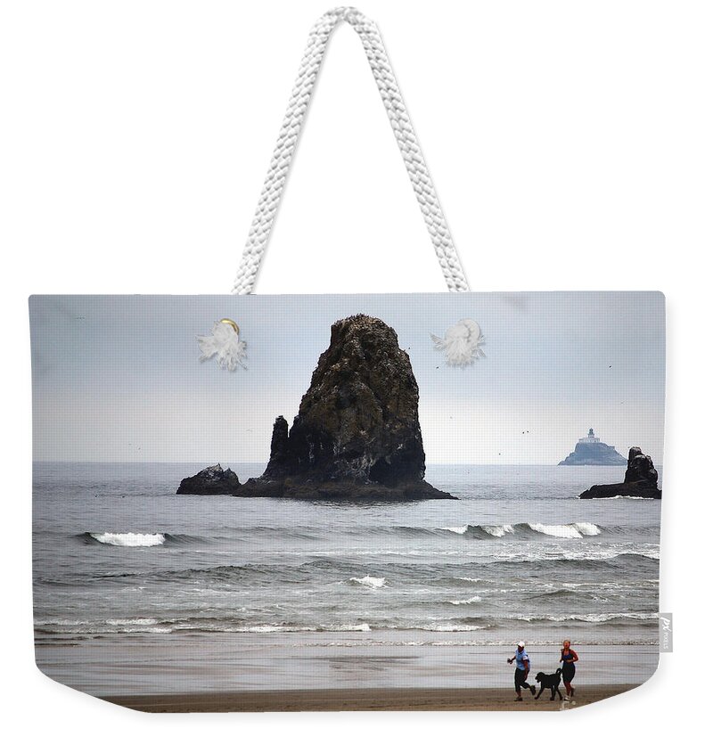 Cannon Beach Weekender Tote Bag featuring the photograph Cannon Beach Run by Sharon Elliott