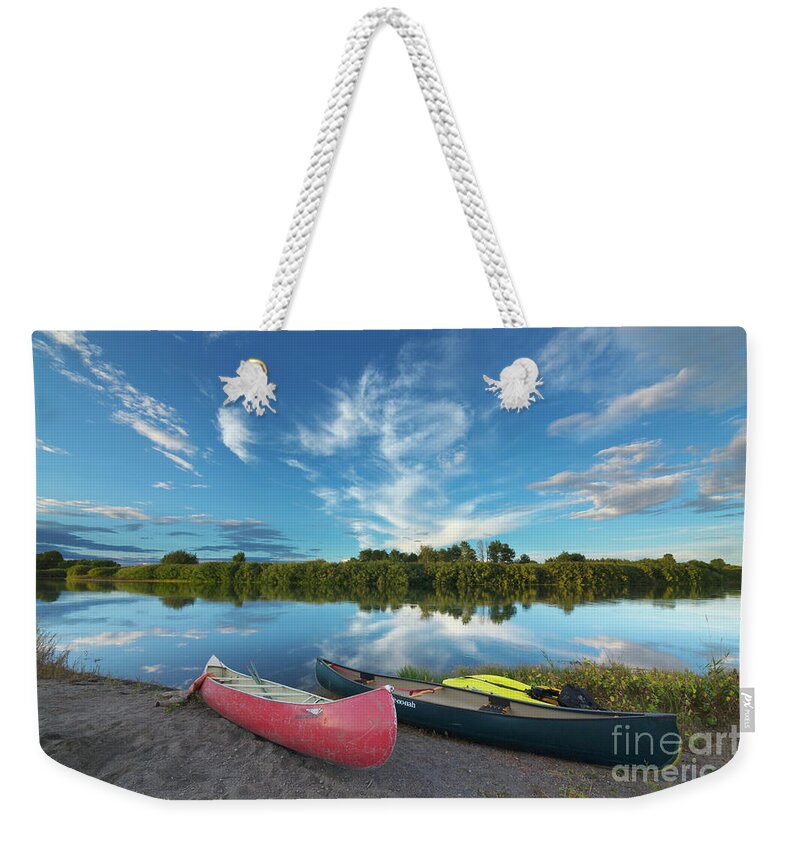 00559205 Weekender Tote Bag featuring the photograph Canoes With Clouds Reflecting by Yva Momatiuk John Eastcott
