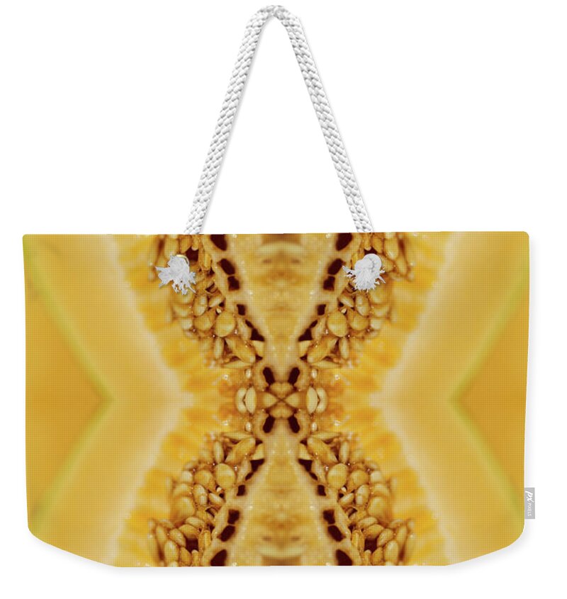 Cantaloupe Weekender Tote Bag featuring the photograph Cantaloupe Seeds Inside A Freshly Cut by Silvia Otte