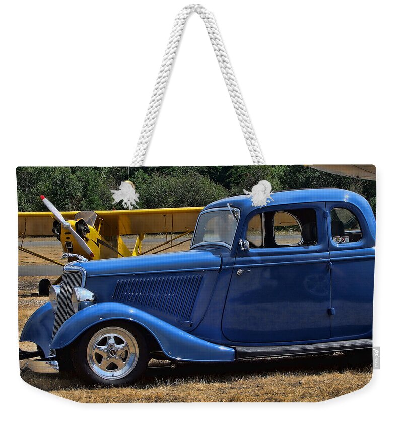 Blue Car Weekender Tote Bag featuring the photograph Car and Plane by Ron Roberts