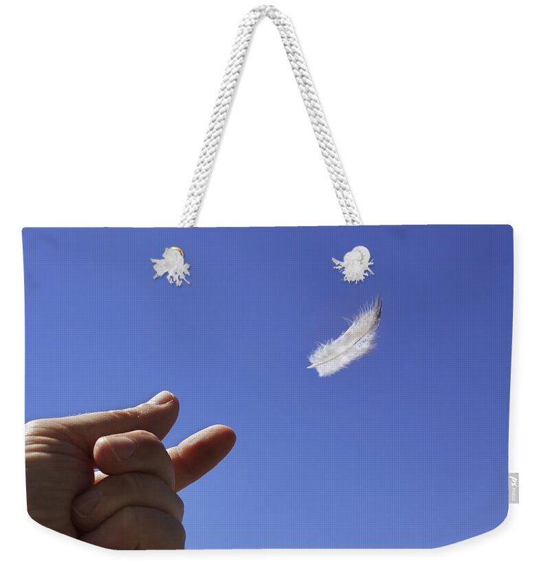 Feather Weekender Tote Bag featuring the photograph Carried on Wind by Jason Politte