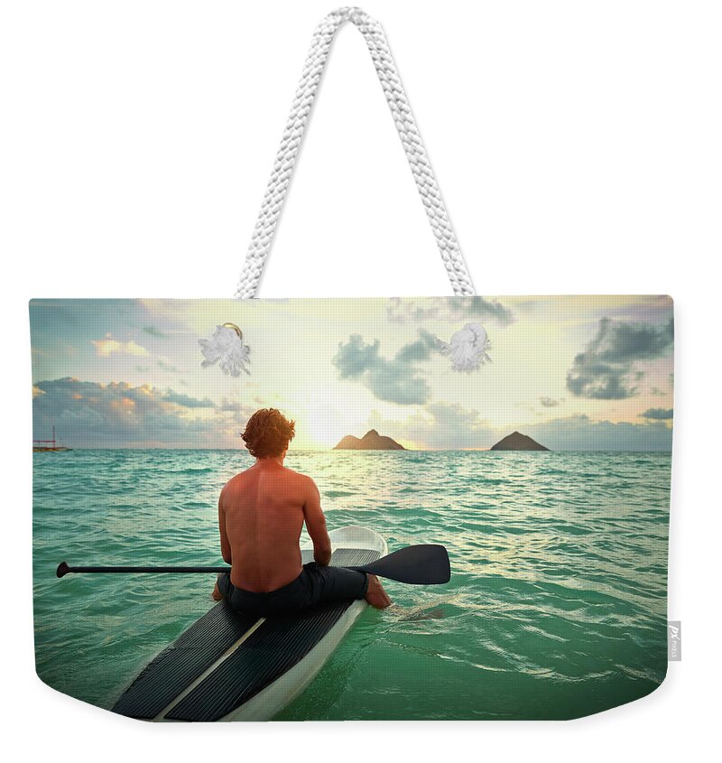 Tranquility Weekender Tote Bag featuring the photograph Caucasian Man On Paddle Board In Ocean by Colin Anderson Productions Pty Ltd