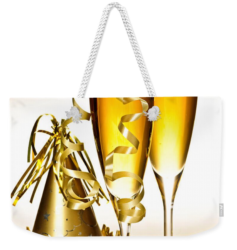 Champagne Weekender Tote Bag featuring the photograph Champagne and New Years party decorations by Elena Elisseeva