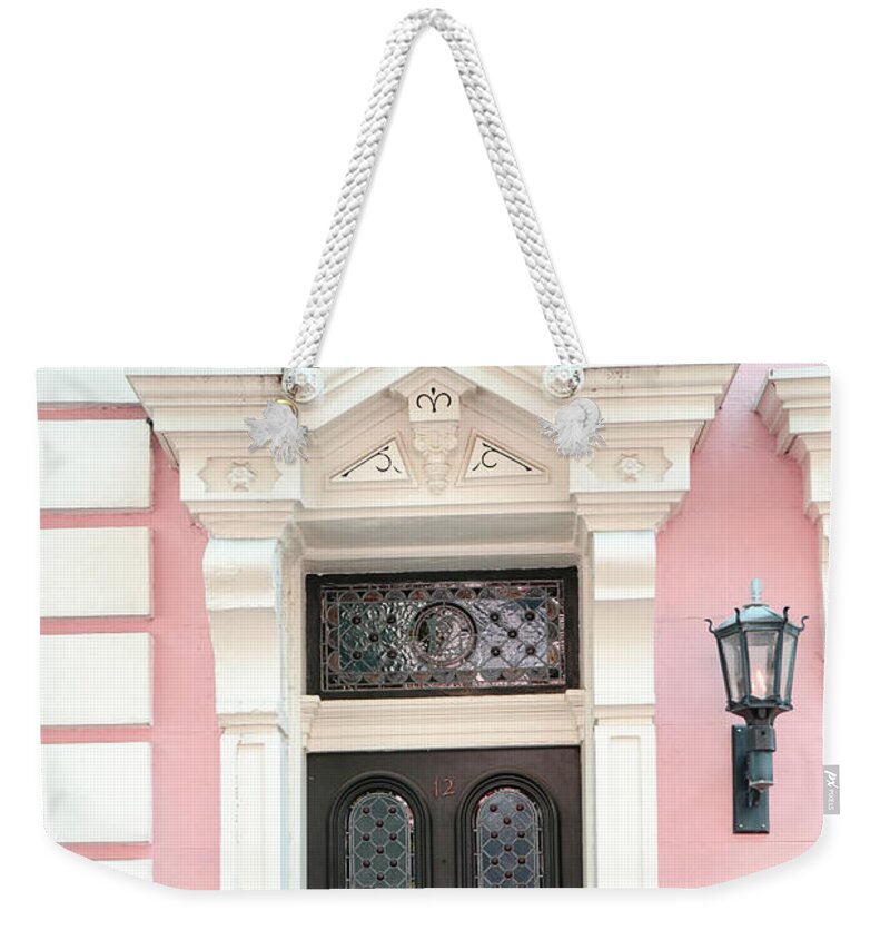 Charleston Weekender Tote Bag featuring the photograph Charleston French Quarter Pink House - Charleston French Architecture Pink Black White Door by Kathy Fornal