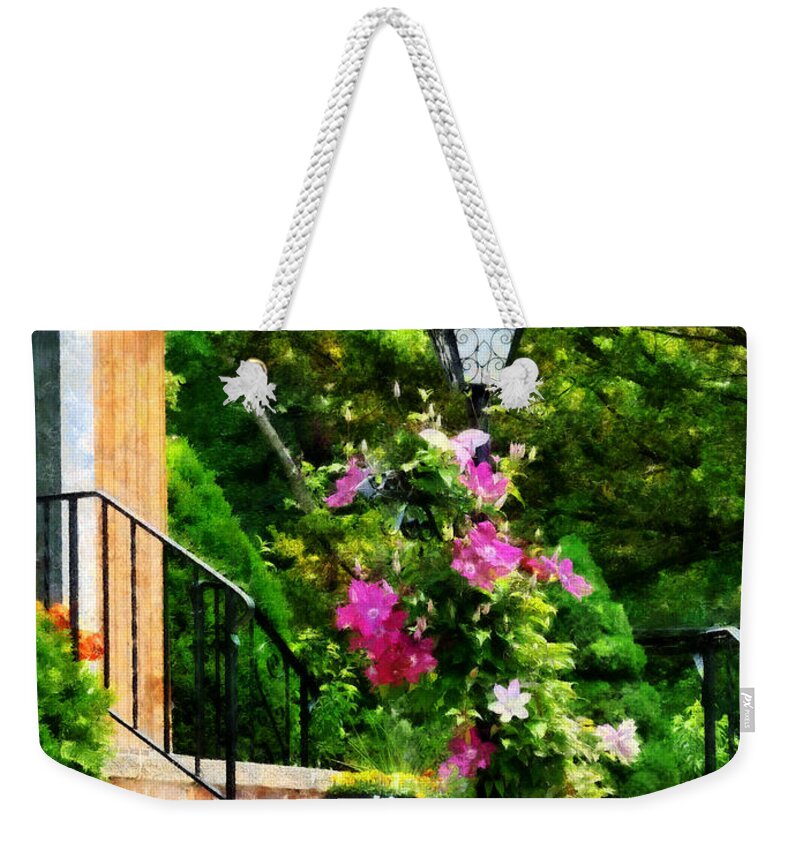 Lamp Post Weekender Tote Bag featuring the photograph Clematis on a Lamp Post by Susan Savad