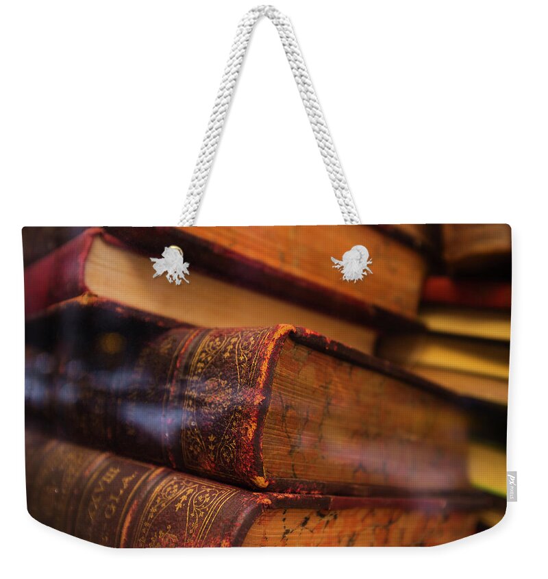 Education Weekender Tote Bag featuring the photograph Close Up Of Antique Books In Leather by Tetra Images