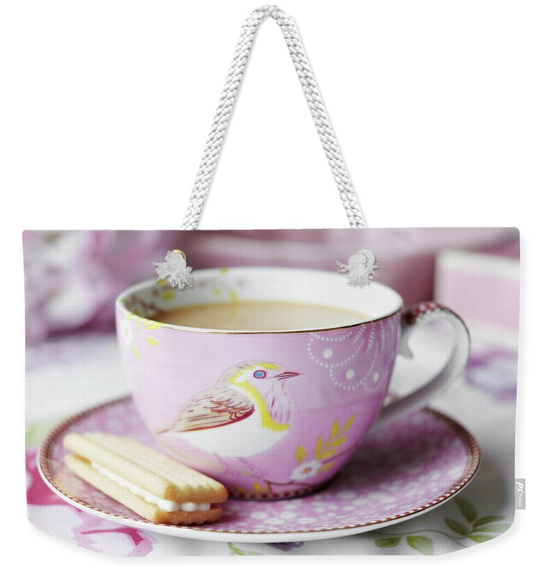 Hot Chocolate Weekender Tote Bag featuring the photograph Close Up Of Cup Of Tea And Cookie by Debby Lewis-harrison