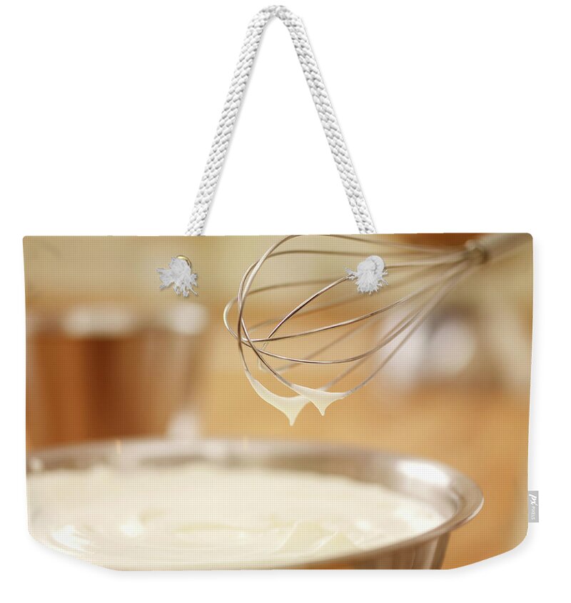 Batter Weekender Tote Bag featuring the photograph Close Up Of Wire Whisk Over Bowl Of by Adam Gault
