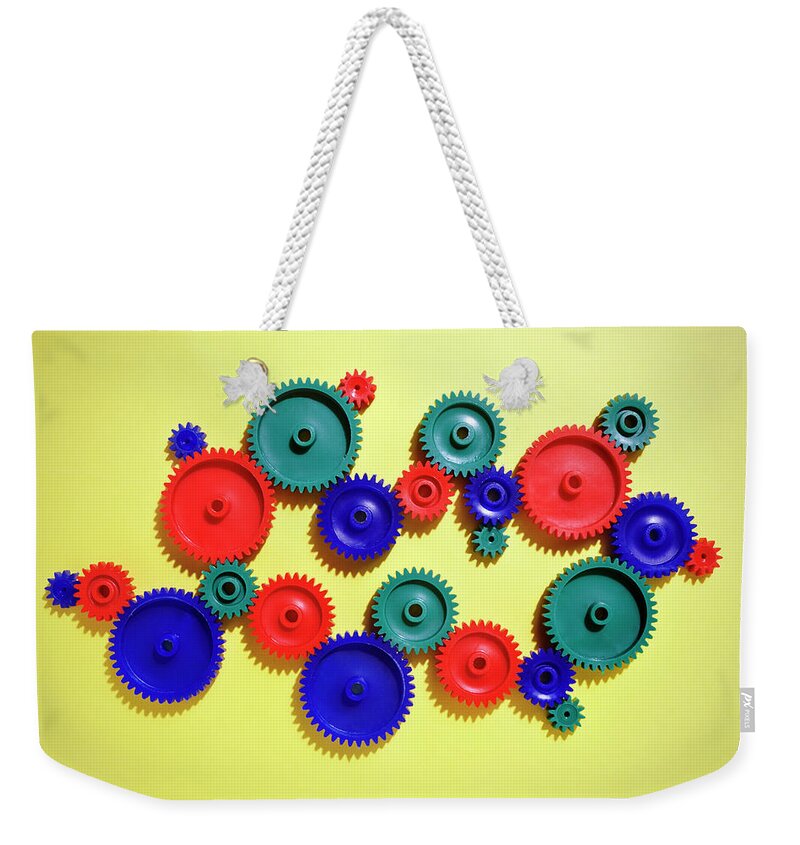 Working Weekender Tote Bag featuring the photograph Colored Gears by Joseph Clark