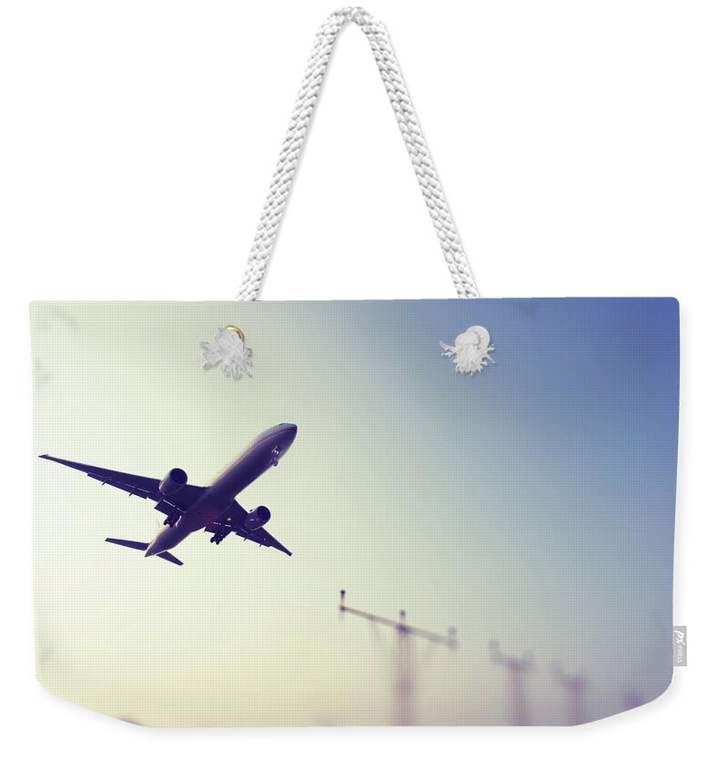 Mid-air Weekender Tote Bag featuring the photograph Commercial Airliner Landing by Greg Bajor