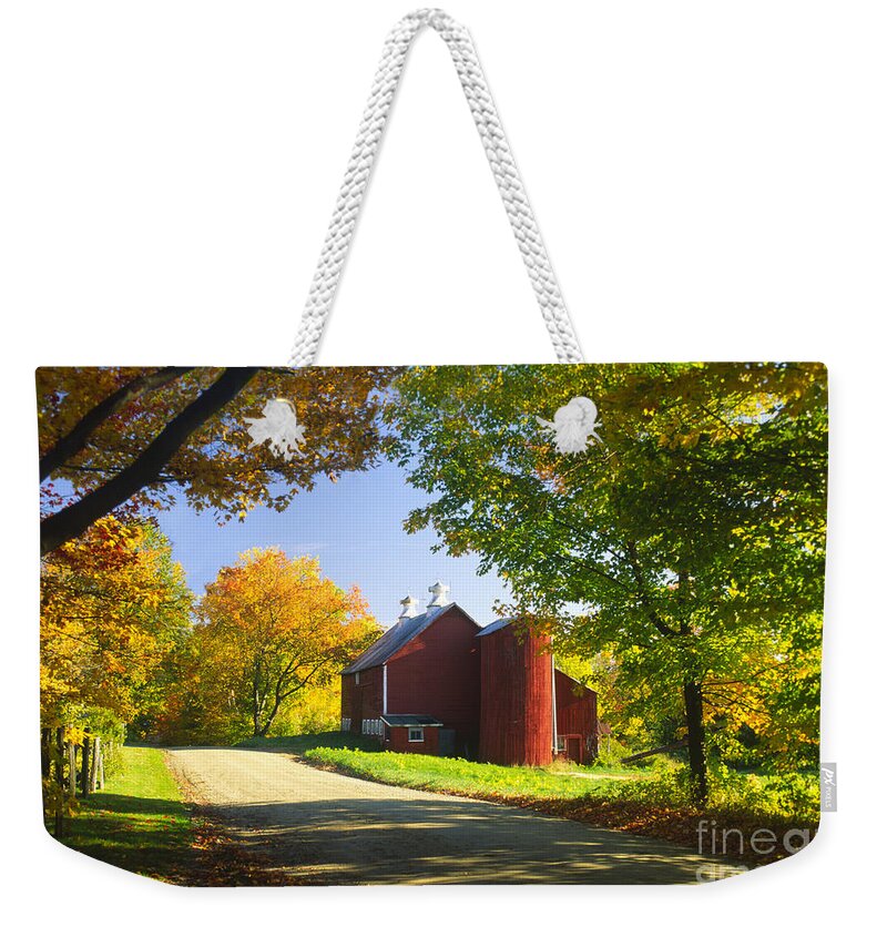 New England Weekender Tote Bag featuring the photograph Country barn on an autumn afternoon. by Don Landwehrle