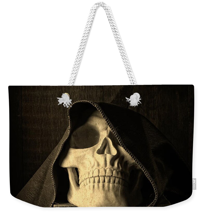 Halloween Weekender Tote Bag featuring the photograph Creepy Hooded Skull by Edward Fielding