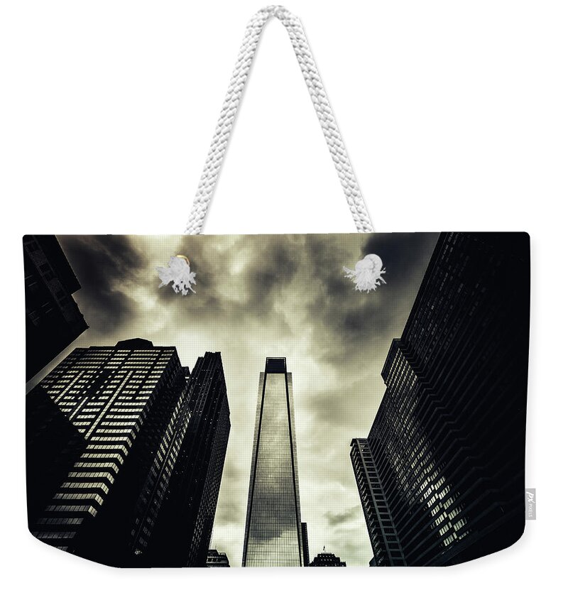 Desaturated Weekender Tote Bag featuring the photograph Dark Clouds And Skyscrapers by Zodebala