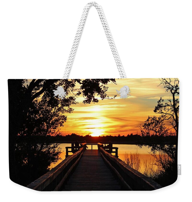 Sunset Weekender Tote Bag featuring the photograph Disappearing Sun by Cynthia Guinn