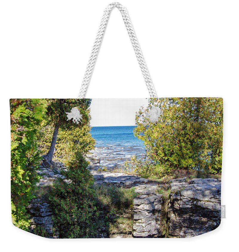 Door County Weekender Tote Bag featuring the photograph Door County's Cave Point by Susan McMenamin