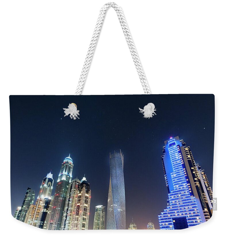Built Structure Weekender Tote Bag featuring the photograph Dubai Marina Skyline At A Starry Night by Pidjoe