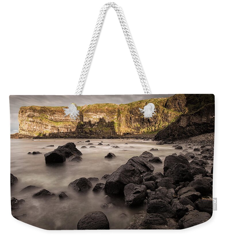 Dunluce Weekender Tote Bag featuring the photograph Dunluce Castle Shadow by Nigel R Bell