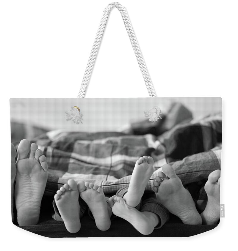 Mid Adult Women Weekender Tote Bag featuring the photograph Eight Human Feet by Christian Gstöttmayr