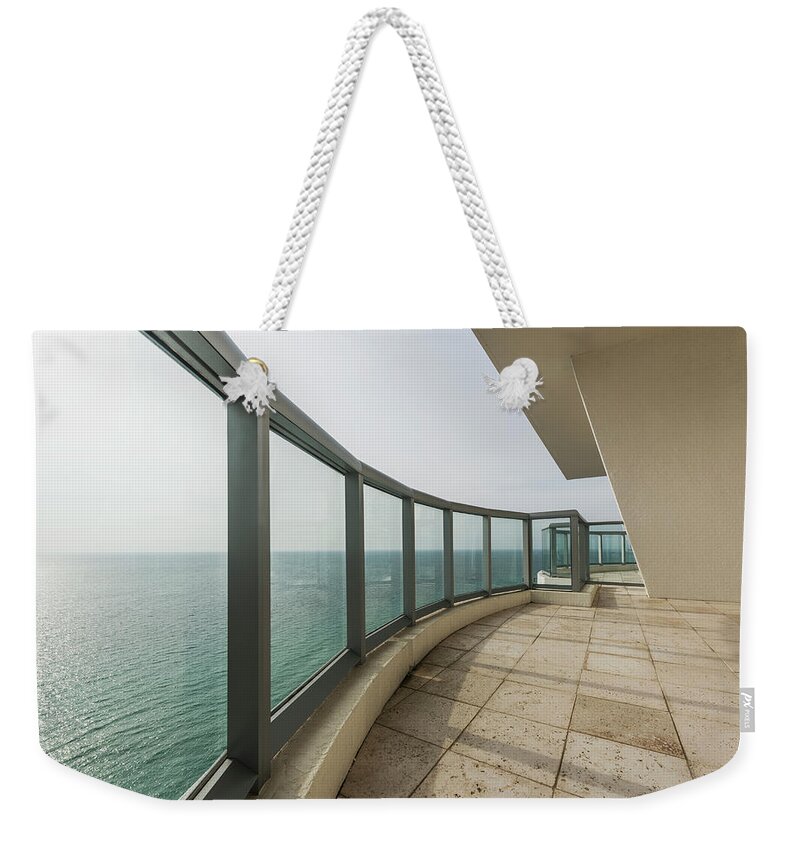 Tranquility Weekender Tote Bag featuring the photograph Empty Rooftop Overlooking Ocean by John M Lund Photography Inc