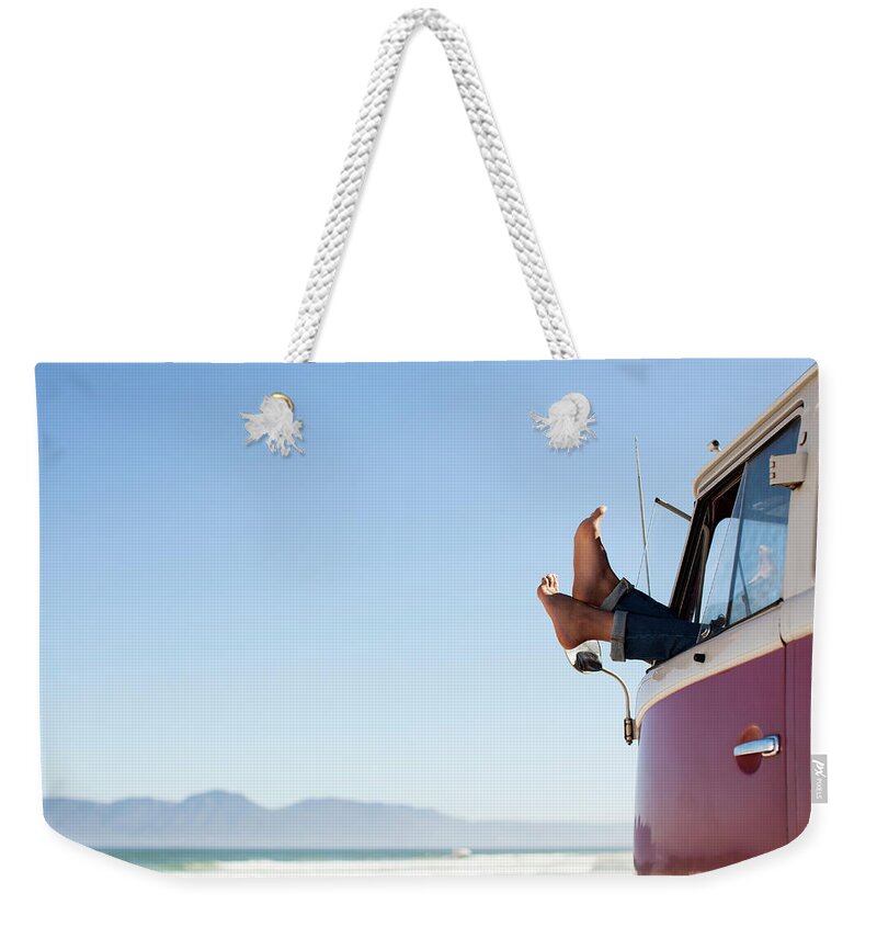 Tranquility Weekender Tote Bag featuring the photograph Feet Sticking Out Of Camper Van Window by David Lees