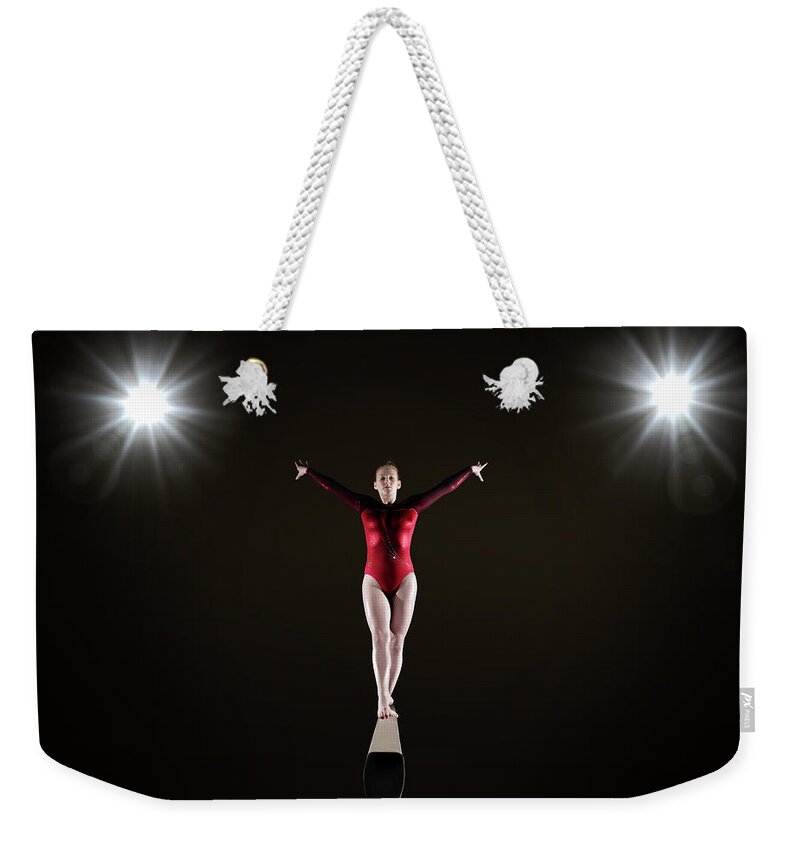 Human Arm Weekender Tote Bag featuring the photograph Female Gymnast On Balance Beam by Mike Harrington
