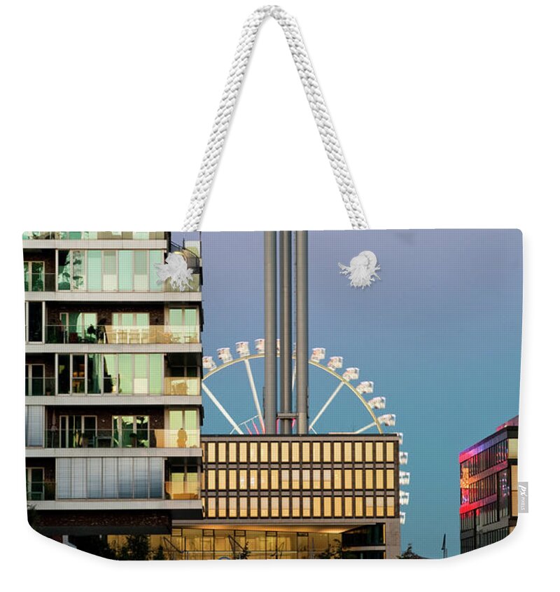 Built Structure Weekender Tote Bag featuring the photograph Ferris Wheel And New Buildings by Thomas Winz