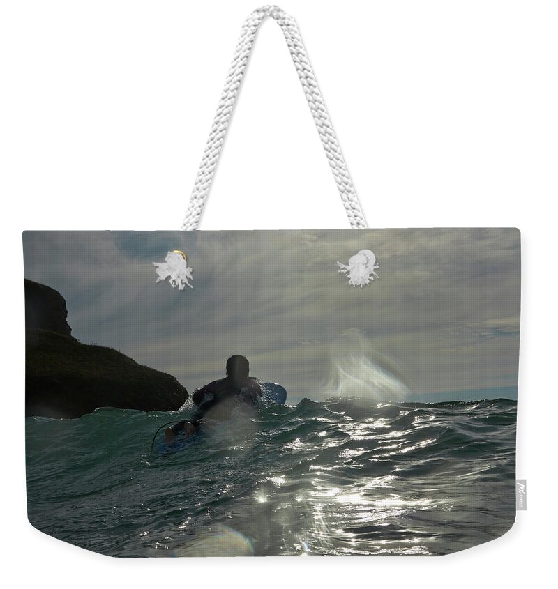 Asian And Indian Ethnicities Weekender Tote Bag featuring the photograph Figure On Surfboard Paddling Out To Sea by Dougal Waters