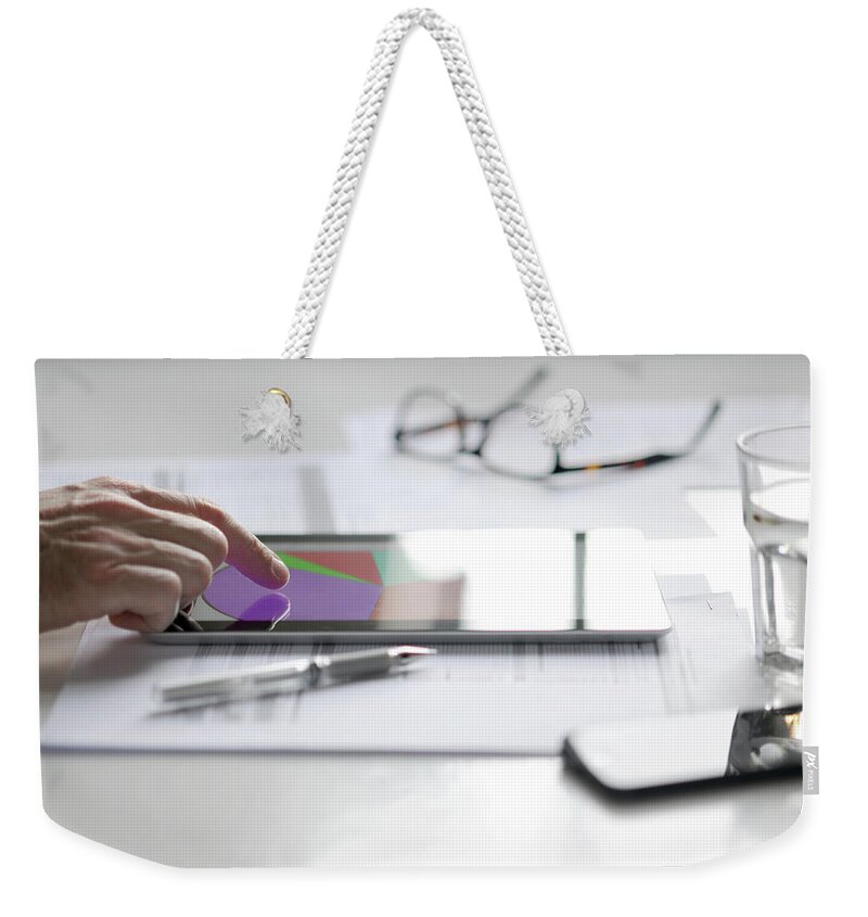 People Weekender Tote Bag featuring the photograph Finger Pointing At Pie Chart On Tablet by Johnnie Davis