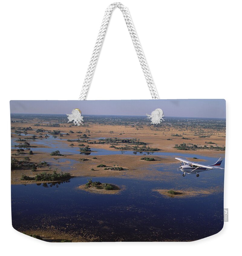 Feb0514 Weekender Tote Bag featuring the photograph Flight Safari Okavango Delta Botswana by Konrad Wothe