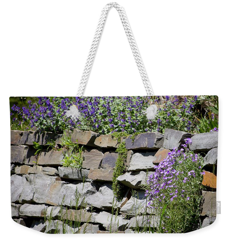 Rock Weekender Tote Bag featuring the photograph Flowers on Rock Wall by Brad Marzolf Photography