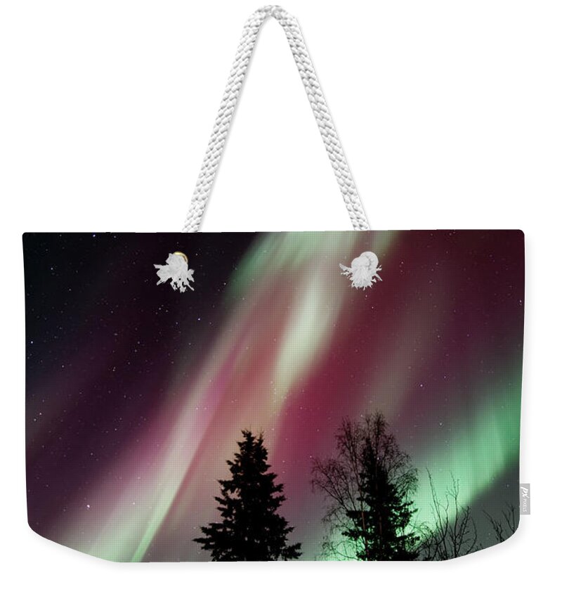 Northern Light Weekender Tote Bag featuring the photograph Flowing Colours by Priska Wettstein