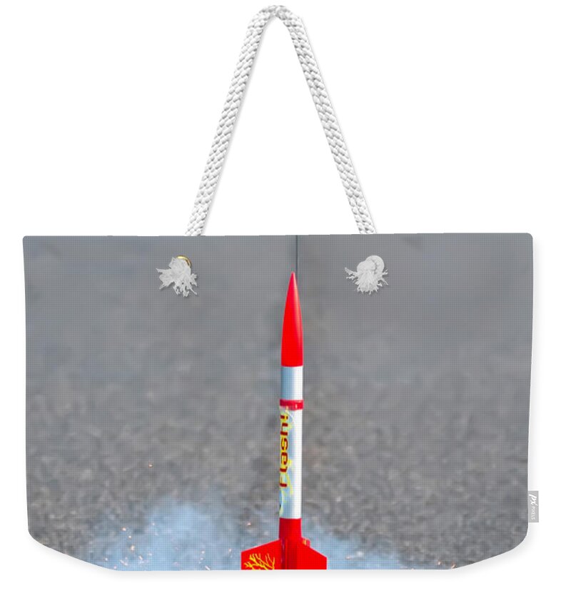 Asphlt Weekender Tote Bag featuring the photograph Flying Model Rocket by Alex Grichenko