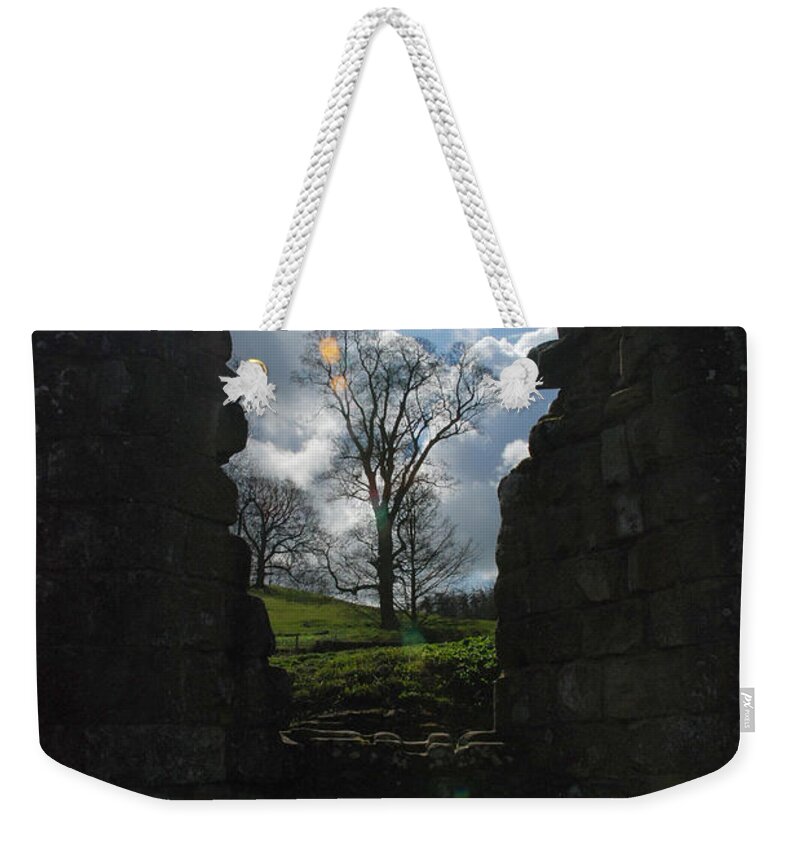 Fountains Abbey Yorkshire Uk Stone Wall Window Sun Ray Tree Arch Weekender Tote Bag featuring the photograph Fountains Abbey by Richard Gibb