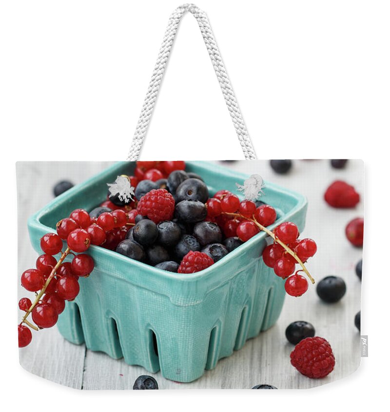 Black Color Weekender Tote Bag featuring the photograph Fresh Berries In Farmer Bowl by Julia Khusainova
