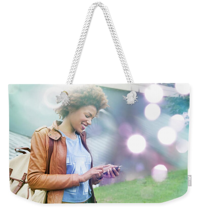 People Weekender Tote Bag featuring the photograph Glowing Lights And Young Woman Using by Innocenti